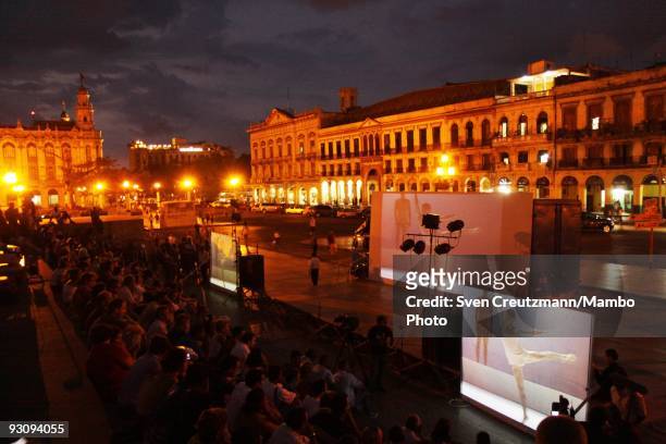 Cubans watch the Royal Ballet "Chroma" performance on three big screens outside the Capitolio, on July 15 in Havana, Cuba. With its first visit to...