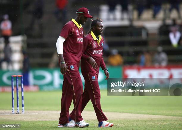 Jason Holder congratulates Kesrick Williams after taking the wicket of Pieter Seelaar of The Netherlands during The ICC Cricket World Cup Qualifier...