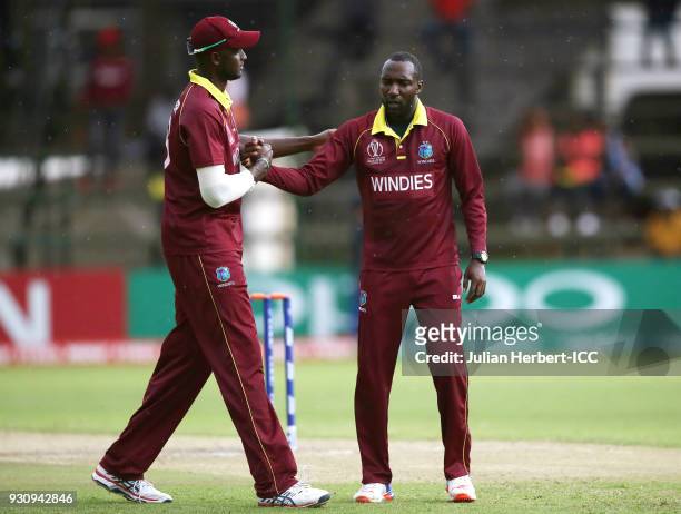 Jason Holder congratulates Kesrick Williams after taking the wicket of Pieter Seelaar of The Netherlands during The ICC Cricket World Cup Qualifier...