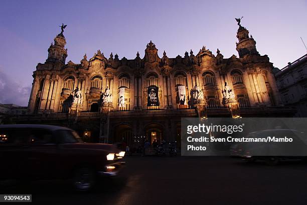 Classic Cars pass by the Gran Teatro where the Royal Ballet performs, July 16 in Old-Havana, Cuba. With its first visit to Cuba, the Royal Ballet of...
