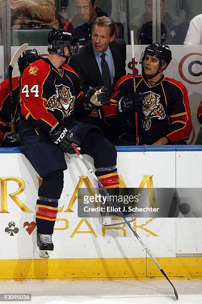Jordan Leopold of the Florida Panthers chats with Assistant Coach Mike Kitchen on the bench during a break in the action against the New York...