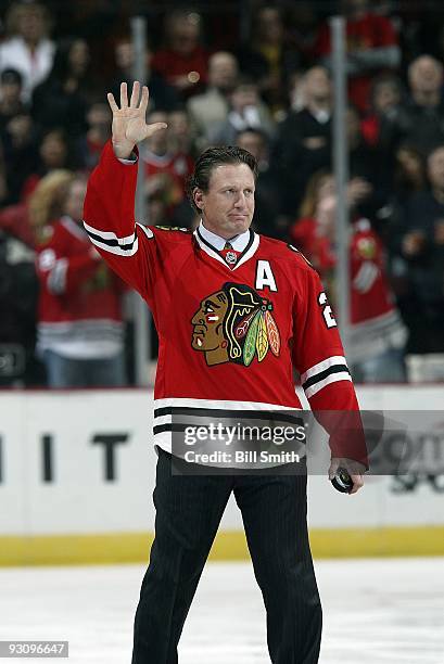 Former Chicago Blackhawks player Jeremy Roenick comes out on the ice to drop the ceremonial puck drop before the game against the San Jose Sharks on...