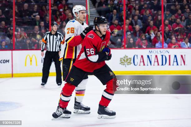Ottawa Senators Left Wing Magnus Paajarvi tangled up with Calgary Flames Defenceman Michael Stone during first period National Hockey League action...