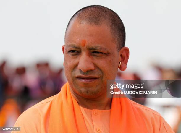 Indian Chief Minister of the state of Uttar Pradesh Yogi Adityanath looks on as Prime Minister Narendra Modi and French President Emmanuel Macron...