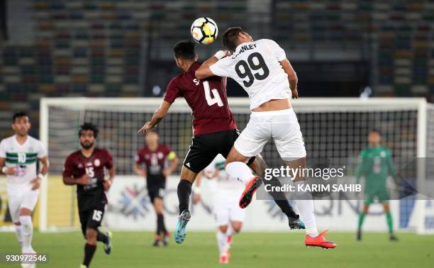 Zob Ahan's forward Kiros vies for the header with Al-Wahda's defender Salem Sultan during the AFC Asian Champions League group B football match on...