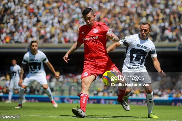 Rubens Sambueza of Toluca struggles for the ball with Marcelo Diaz of Pumas during the 11th round match between Pumas UNAM and Toluca as part of the...