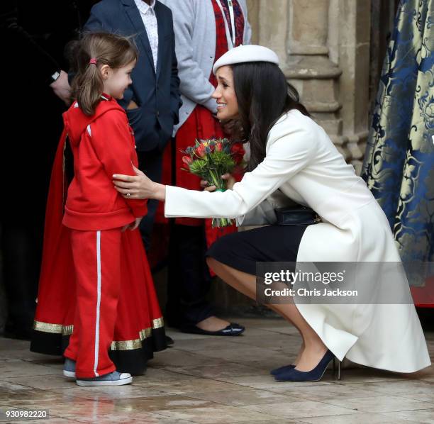 Meghan Markle greets a child as she departs the 2018 Commonwealth Day service at Westminster Abbey on March 12, 2018 in London, England.