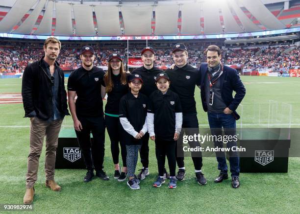 Heuer Ambassador Chris Hemsworth and TAG Heuer President North America Kilian Muller pose with local rugby players after TAG Heuer donates money to...