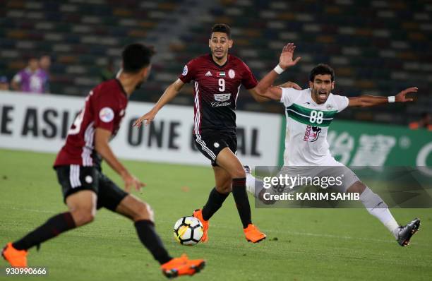 Zob Ahan's midfielder Hamid Bou Hamdan is dispossessed by Al-Wahda's forward Mourad Batna during the AFC Asian Champions League group B football...