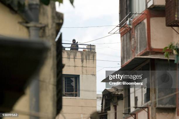 National Security Guard commando stands guard as firing breaks out at Nariman House in Mumbai, India, on Friday, Nov. 28, 2008. About 200 people were...