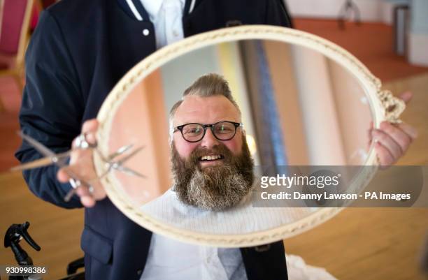 Glen Daniels admires his beard after being styled by award winning master barber Yucel Olmezkaya has he attends day two of Yorkshire Beard Days 2018...