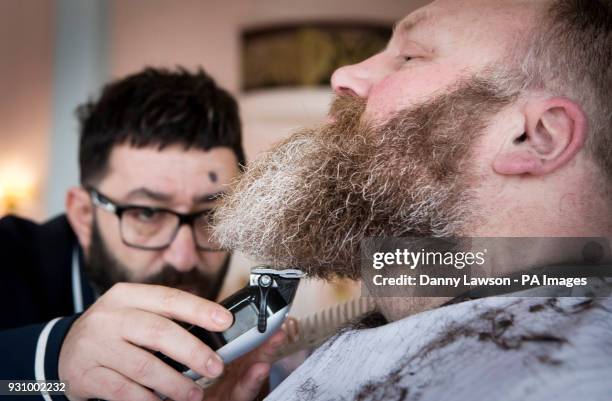 Award winning master barber Yucel Olmezkaya styles the beard of Glen Daniels during day two of Yorkshire Beard Days 2018 at the Grand Hotel in...