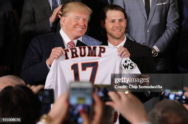 President Donald Trump poses for photographs with Houston Astros outfielder Josh Reddick while celebrating the team's World Series victory in the...
