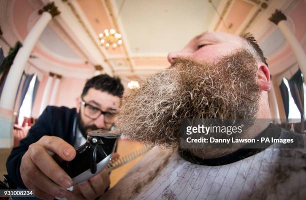 Award winning master barber Yucel Olmezkaya styles the beard of Glen Daniels during day two of Yorkshire Beard Days 2018 at the Grand Hotel in...