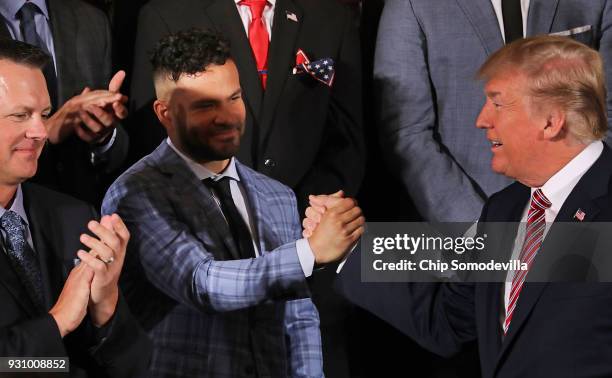 President Donald Trump congratulates Houston Astros second baseman Jose Altuve while celebrating the team's World Series victory in the East Room of...