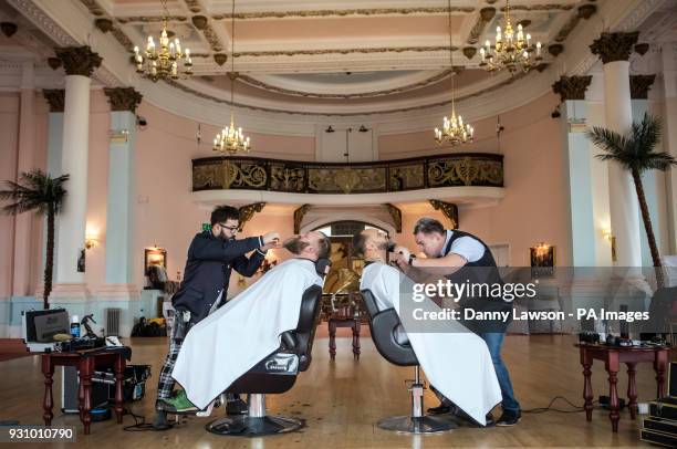Award winning master barbers Yucel Olmezkaya and Robert Grosvenor style the beards of Glen Daniels and Jonno Harris during day two of Yorkshire Beard...