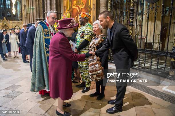 Britain's Queen Elizabeth II greets former One Direction member Liam Payne after attending a Commonwealth Day Service at Westminster Abbey in central...