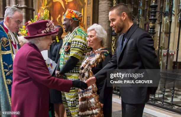 Britain's Queen Elizabeth II greets former One Direction member Liam Payne after attending a Commonwealth Day Service at Westminster Abbey in central...
