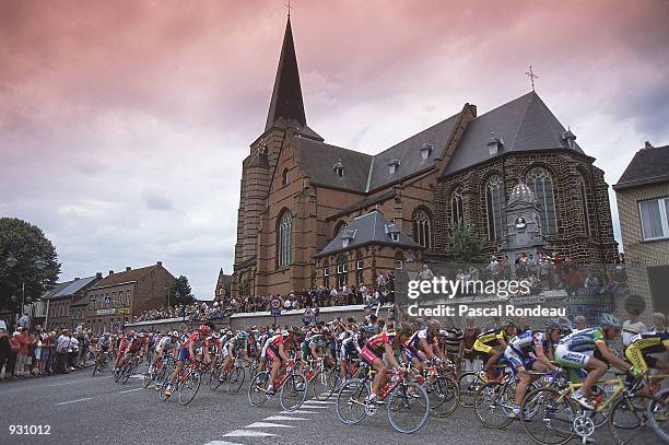 The Peloton passes a church during the Calais to Anvers stage two of the Tour De France 2001 in Calais , France. Mandatory Credit: Pascal...