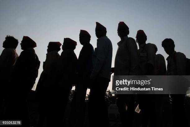 Farmers stand in queue to take free vada pav during farmers protest march at Azad Maidan on March 12, 2018 in Mumbai, India. Over 30,000 farmers from...