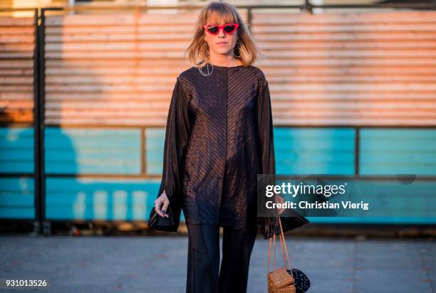 Einat Rozen wearing flared pants with slit, black blouse is seen during Tel Aviv Fashion Week on March 12, 2018 in Tel Aviv, Israel.