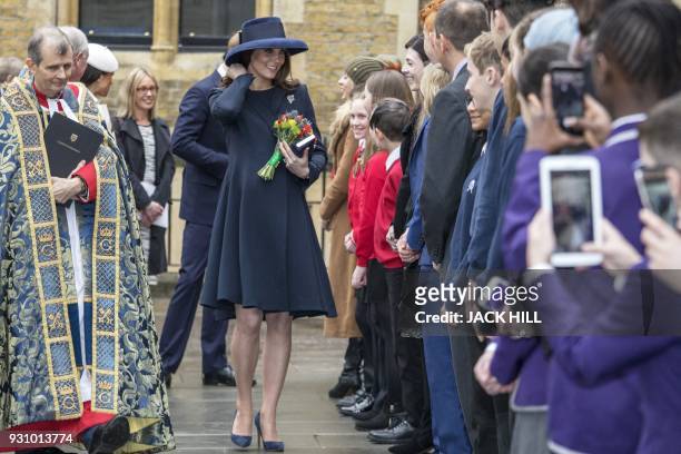 Britain's Catherine, Duchess of Cambridge meets school children in the Dean's yard before attending a Reception in central London, on March 12, 2018....