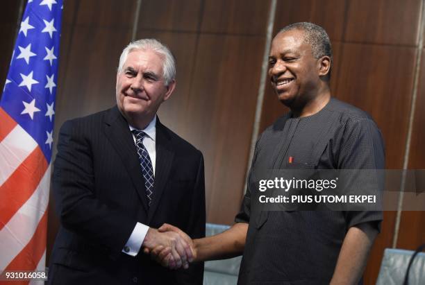 Secretary of State Rex Tillerson and Nigeria's Foreign Minister Geoffrey Onyeama shake hands after a joint press conference in Abuja on March 12,...