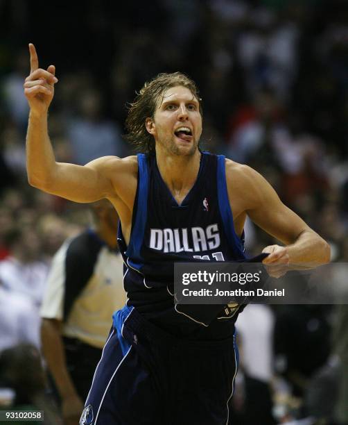 Dirk Nowitzki of the Dallas Mavericks celebrates hitting the game-winning shot with 3.3 seconds on the clock against the Milwaukee Bucks at the...