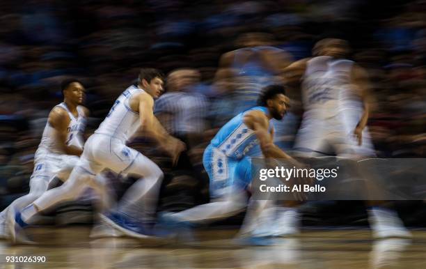 Joel Berry II of the North Carolina Tar Heels drives against Grayson Allen of the Duke Blue Devils during the semifinals of the ACC Men's Basketball...