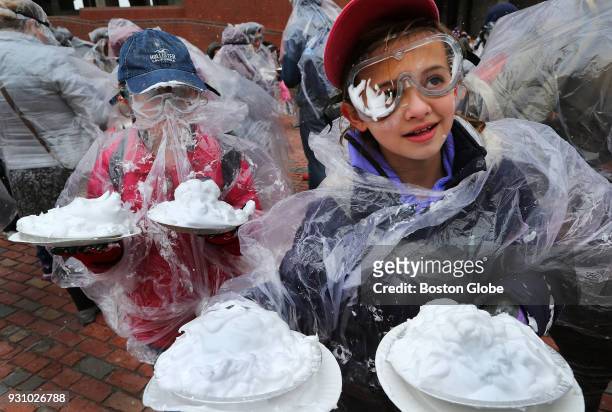 Olivia Wells left, and Emily Grenadine both from Methuen, have their pies ready to throw as hundreds gather to throw shaving cream pies in Boston...