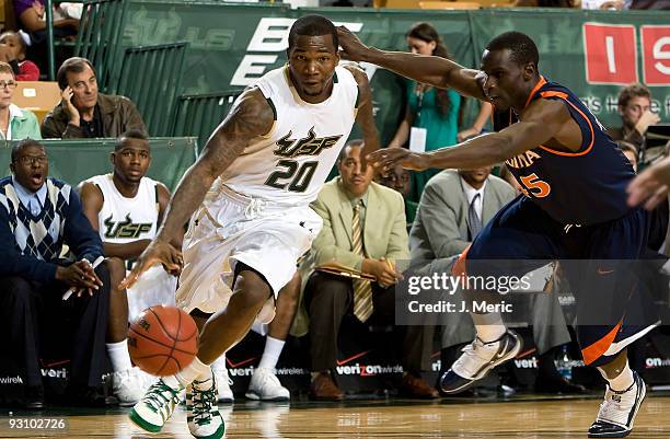 Guard Dominique Jones of the South Florida Bulls drives to the basket against the Virginia Cavaliers during the game at the SunDome on November 16,...