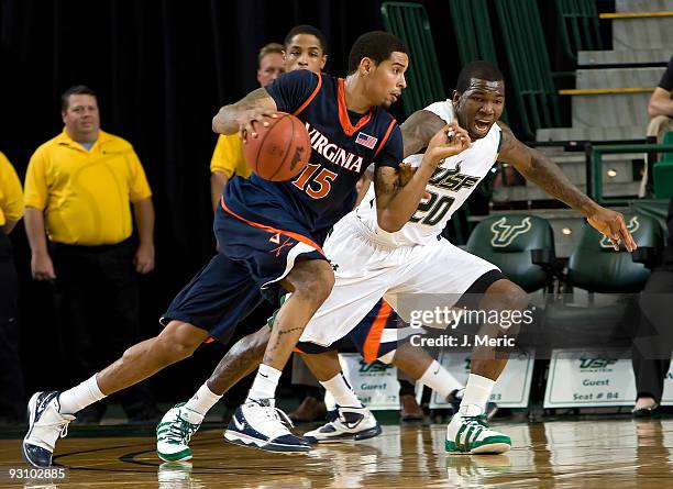 Guard Sylven Landesberg of the Virginia Cavaliers drives on guard Dominique Jones of the South Florida Bulls during the game at the SunDome on...