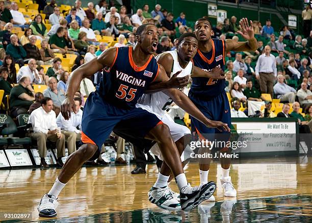 Forward Jerome Meyinsse of the Virginia Cavaliers battles Augustus Gilchrist of the South Florida Bulls during the game at the SunDome on November...