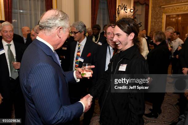 Prince Charles, Prince of Wales meets Daniel Hatton of the Commonwealth Fashion Council as they attend the 2018 Commonwealth Day reception at...