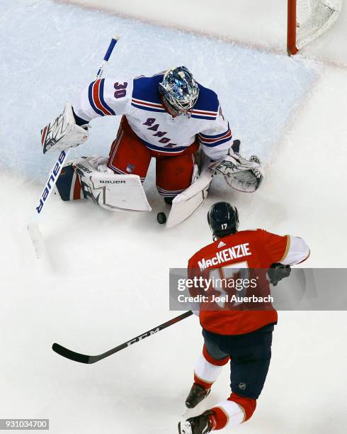 Goaltender Henrik Lundqvist of the New York Rangers stops a shot by Derek MacKenzie of the Florida Panthers at the BB&T Center on March 10, 2018 in...