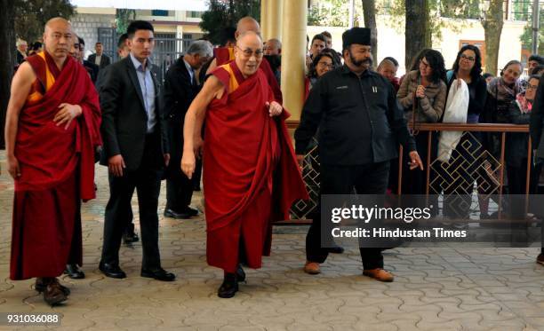 Tibetan spiritual leader Dalai Lama greets devotees as he arrives to attend the Mind and Life XXXIII conference at the main Buddhist temple,...