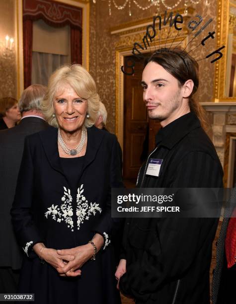 Britain's Camilla, Duchess of Cornwall poses next to Daniel Hatton of the Commonwealth Fashion Council at the 2018 Commonwealth Day reception at...