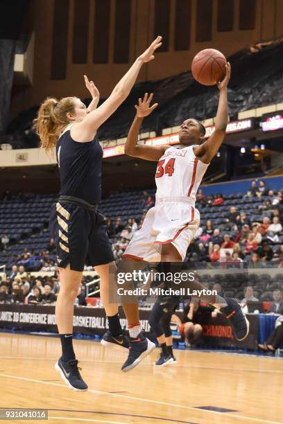 Javonna Layfield of the Dayton Flyers takes a shot over Kelsi Mahoney of the George Washington Colonials during the semifinal round of the...