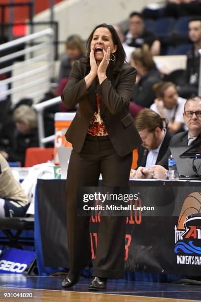 Head coach Jennifer Rizzotti of the George Washington Colonials yells to her players during the semifinal round of the Atlantic-10 Women's Basketball...