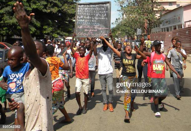 People demonstrate in central Conakry on March 12 in a day of protest against Guinea's President. Thousands of people demonstrated in central Conakry...
