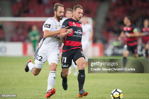 Brendon Santalab of the Wanderers is challenged by Phoenix's Andrew Durante during the round 22 A-League match between the Western Sydney Wanderers...