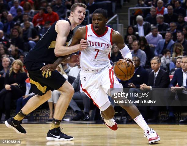 Joe Johnson of the Houston Rockets dribbles the ball as Jakob Poeltl of the Toronto Raptors defends during the first half of an NBA game at Air...