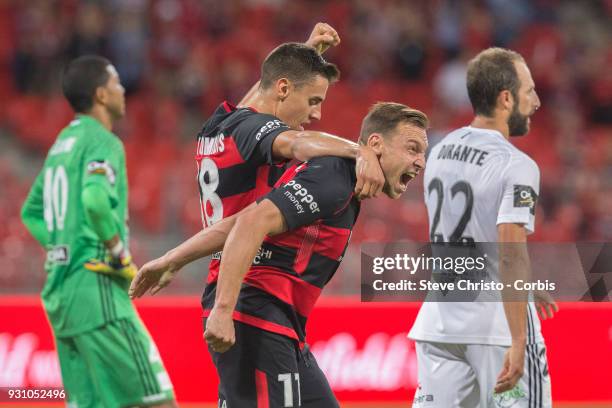 Brendon Santalab of the Wanderers celebrates scoring a goal with teammate Christopher Iknoomidis during the round 22 A-League match between the...