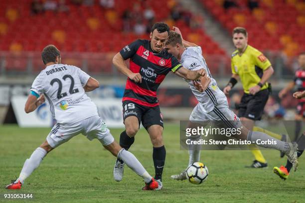 Mark Bridge of the Wanderers is caught up in this tackle by Phoenix'x Andrew Durante and Dylan Fox during the round 22 A-League match between the...
