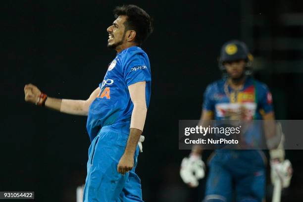 Indian cricketer Yuzvendra Chahal celebrates after taking a wicket during the 4th Twenty-20 cricket match of NIDAHAS Trophy between Sri Lanka and...