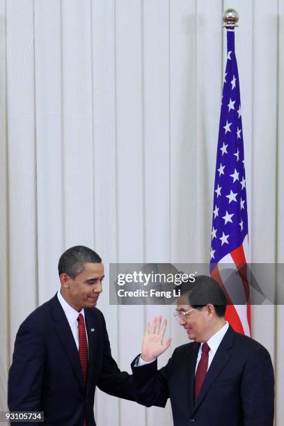 Chinese President Hu Jintao gestures to U.S. President Barack Obama after a joint press conference at the Great Hall of People on November 17, 2009...