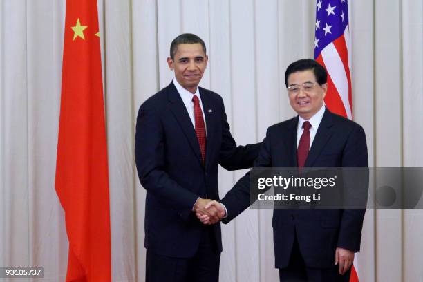 President Barack Obama shakes hands with Chinese President Hu Jintao after a joint press conference at the Great Hall of People on November 17, 2009...