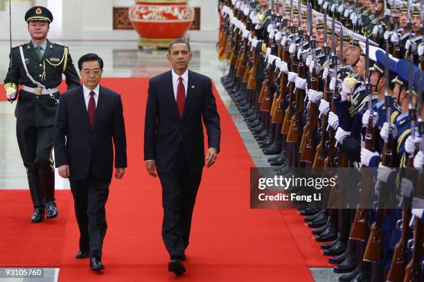 President Barack Obama inspects a guard of honor along with Chinese President Hu Jintao at the Great Hall of the People on November 17, 2009 in...