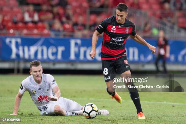 Christopher Ikonomidis of the Wanderers gets past Phoenix's Scott Galloway to score a goal during the round 22 A-League match between the Western...