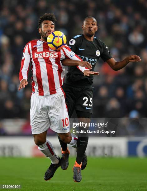 Maxim Choupo-Moting of Stoke City shields the ball from Fernandinho of Manchester City during the Premier League match between Stoke City and...